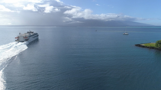 Moorea, aerial view of a ferry boat leaving the bay of Vaiare, 4K UHD