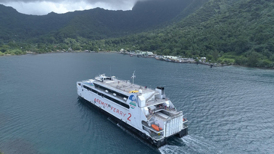 Moorea, aerial view of a ferry boat in the bay of Vaiare, 4K UHD