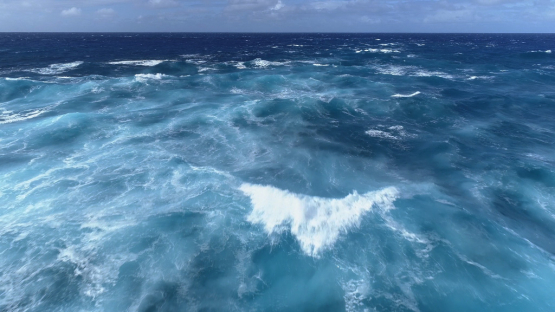 Huahine, aerial view of agitated waves in the pass, 4K UHD