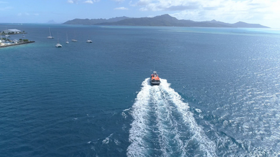 Raiatea, aerial view of a boat transporting pessengers to Tahaa island, 4K UHD