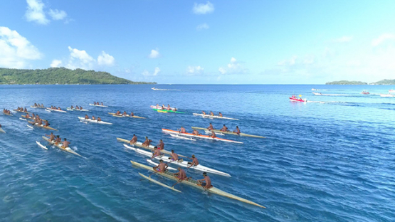 Bora Bora, aerial view of a race of traditional outrigger canoes in the lagoon, 4K UHD