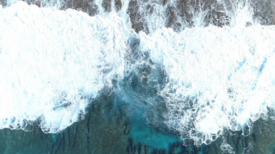 Maupiti, aerial view above waves breaking on the barrier reef, 4K UHD