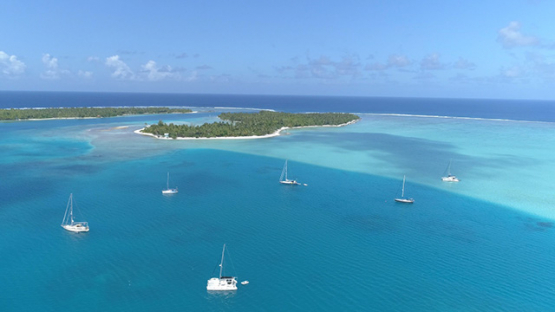 Maupiti, aerial view of sail boats anchored near the pass Onoiau, 4K UHD