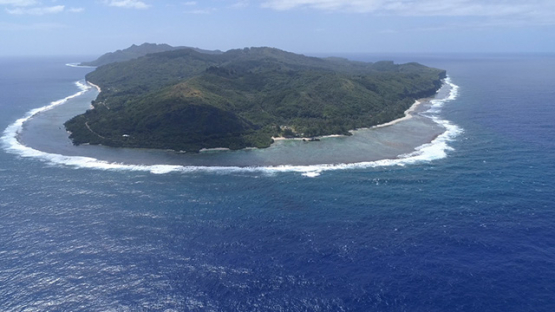 Rurutu, aerial view of the island surrounded by the ocean, 4K UHD