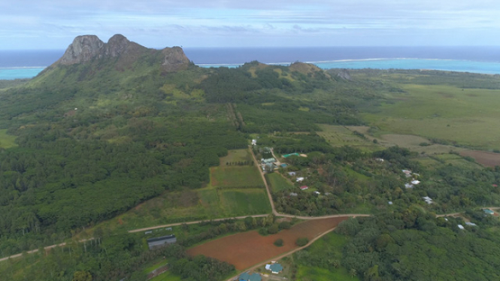 Tubuai, aerial view of the farming lands of the plain of Huahine and Mountain Laying man, 4K UHD