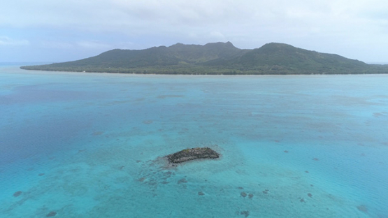 Tubuai, aerial view of the rocky islet Ofai and the island, 4K UHD