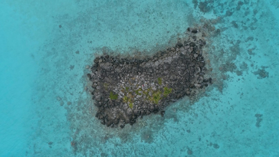 Tubuai, aerial view of the rocky islet Ofai in the lagoon, 4K UHD