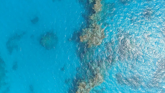 Tubuai, aerial view above the lagoon and coral reef, 4K UHD