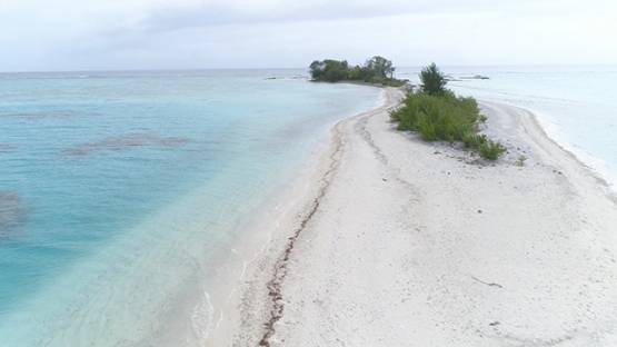 Tubuai, aerial view of the islet Motu Rautaro behind the barrier reef, 4K UHD