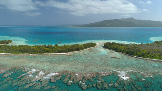 Tubuai, aerial view of the islet Motu Roa behind the barrier reef, 4K UHD