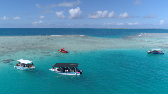 Rangiroa, aerial view of the blue lagoon, boats of tourists, 4K UHD