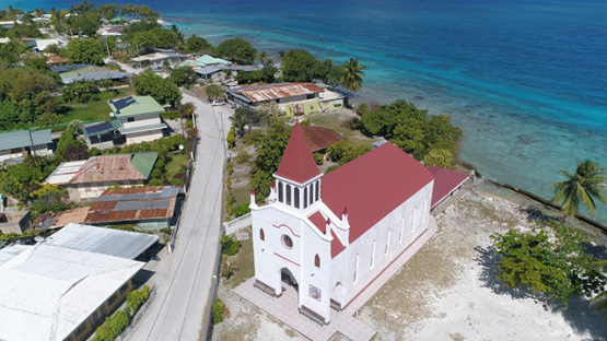 Rangiroa, aerial view of the church and bell tower of the village Avatoru, 4K UHD