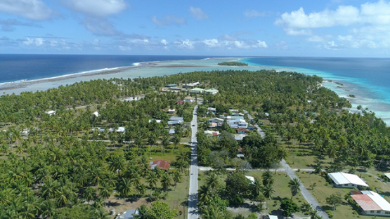 Tikehau, aerial view above the main street of the village Tuherahera, 4K UHD