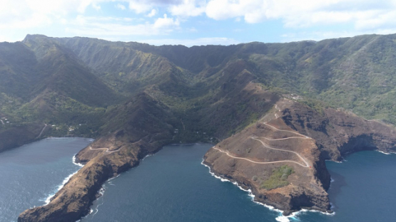 Hiva Oa, aerial view of the road along the rocky coast of Puamau, 4K UHD