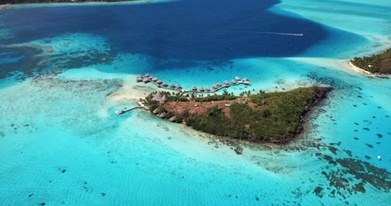 Bora Bora 4k drone, aerial descending view of a resort in front of the lagoon