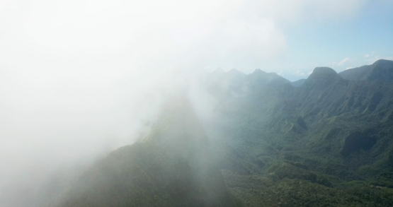 Tahiti 4K drone, aerial view of Mount Marau edge out of the clouds