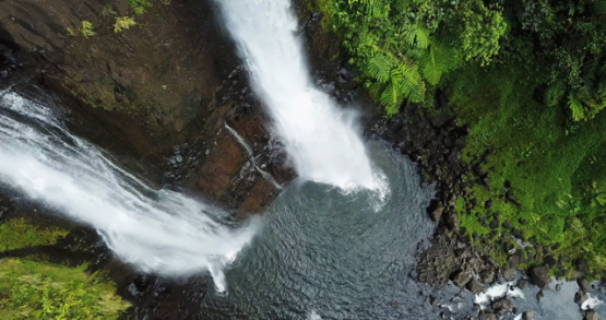 Tahiti 4K drone, aerial descending view of a waterfall in Hitiaa valley