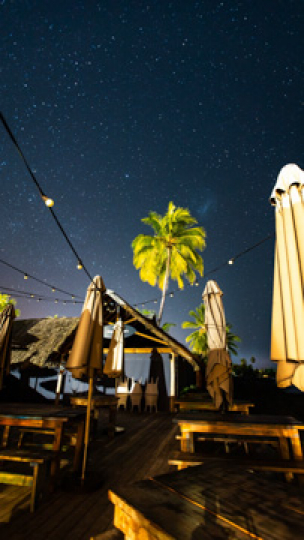 Tahiti, a stary night timelapse from a bar terrace, vertical 4K UHD