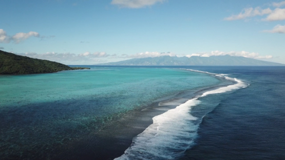 Aerial view by drone of west coast of Moorea and barrier reef, 4K UHD