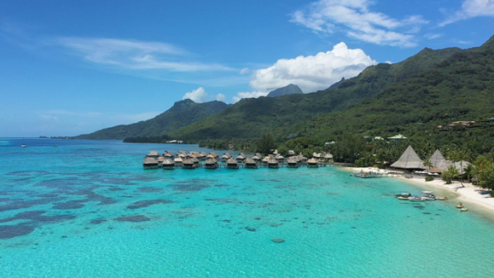 Aerial drone view of the lagoon of Moorea, white sand beach and hotel