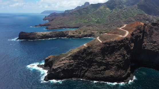 Hiva Oa, aerial drone view of the coast line and road of Puamau