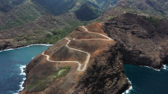 Hiva Oa, aerial drone view of the coast line and road of Puamau