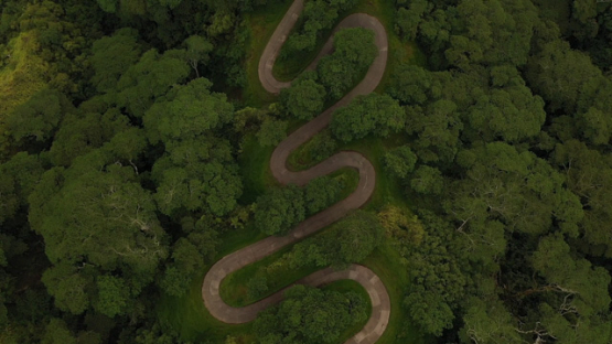 Hiva Oa, aerial drone top down view of the road in the mountain  and forest