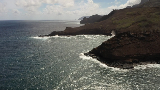 Hiva Oa, aerial drone view of the rocky coast line and ocean