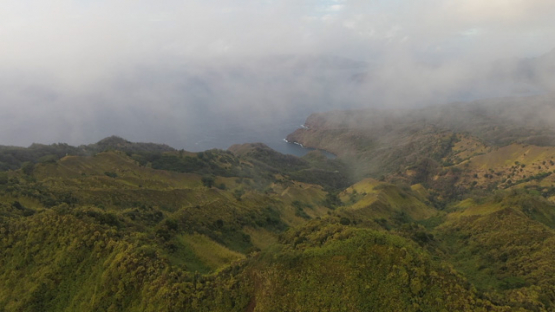 Hiva Oa, aerial drone view from the top of the mountain under the cloud