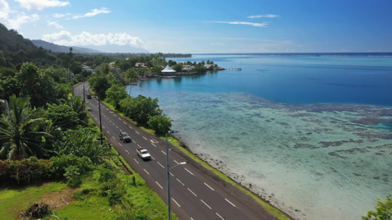Tahiti, aerial drone view of the coast line and traffic on Paea road