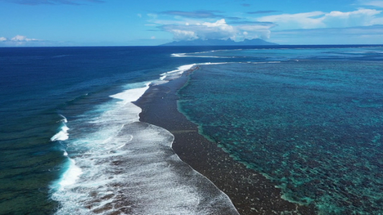 Tahiti, aerial drone view along the barrier reef, Moorea in the background
