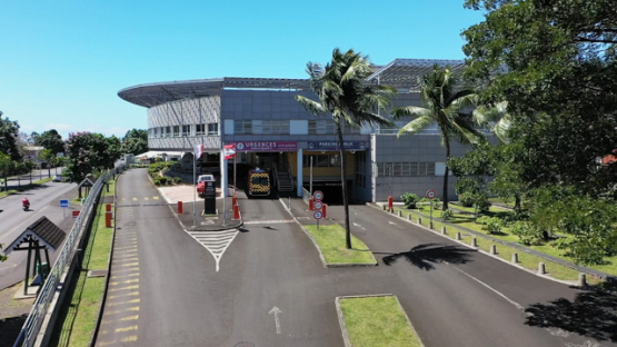 Aerial drone view of Tahiti, ambulance arriving at the hospital