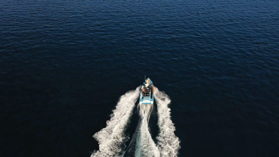 Tahiti, aerial view by drone of fishing boat in the lagoon of Taravao