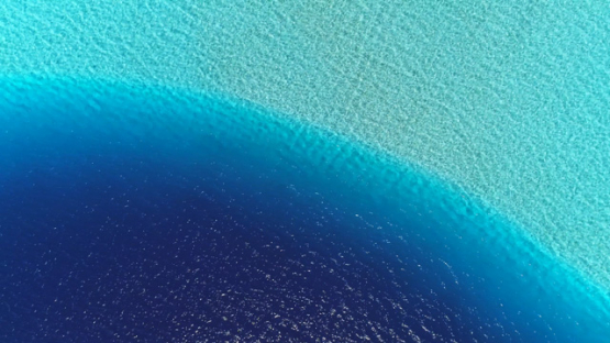 Aerial top down view above the turquoise lagoon, 4K UHD