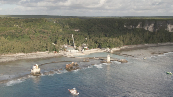 Aerial drone view of the island Makatea, old pier with rusted structures, 2K7