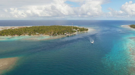 Fakarava, aerial view by drone of a motor boat in the pass Tetamanu, 4K UHD
