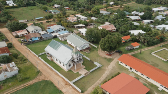 Rimatara, aerial view by drone of the church in the village of Mutuaura, 4K UHD