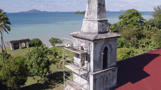 Taravai, Aerial drone view of the church Saint-Gabriel and bell tower, Gambier archipelago, 4K UHD