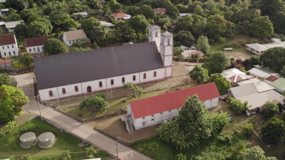 Mangareva, Aerial drone view over Rikitea and Cathedrale Saint-Michel, 4K UHD