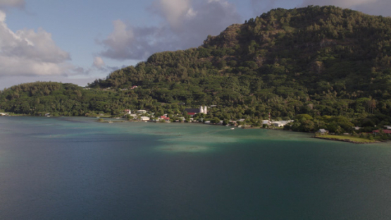 Gambier archipelago, aerial drone view of Rikitea from over the lagoon, Mangareva, 4K UHD