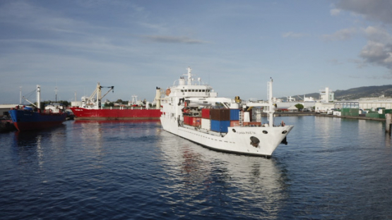 Cargo ship leaving the harbour of Papeete, Tahiti, French Polynesia