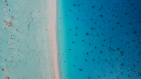 Hikueru, Aerial top view of atoll, Tuamotu, Barrier reef, blue Lagoon, UHD