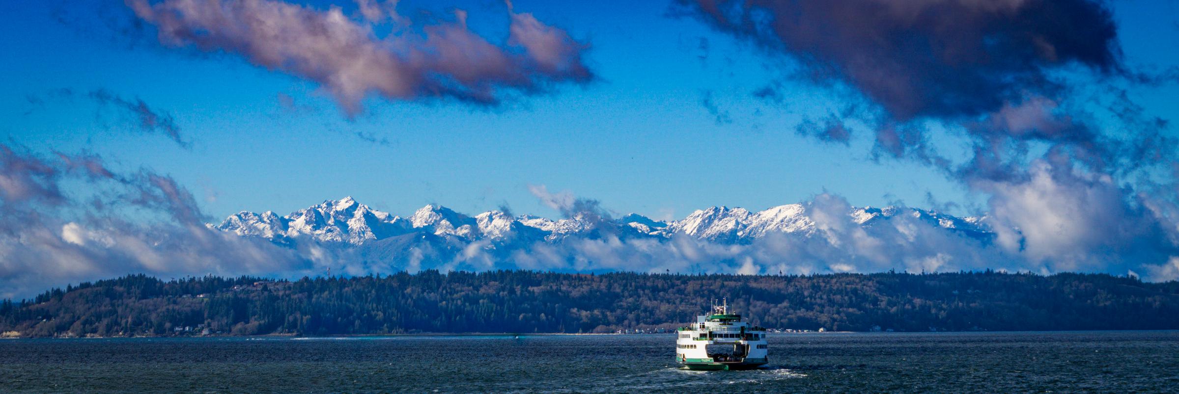 Ferry on the water with snow-capped mountains Seattle Washington United States