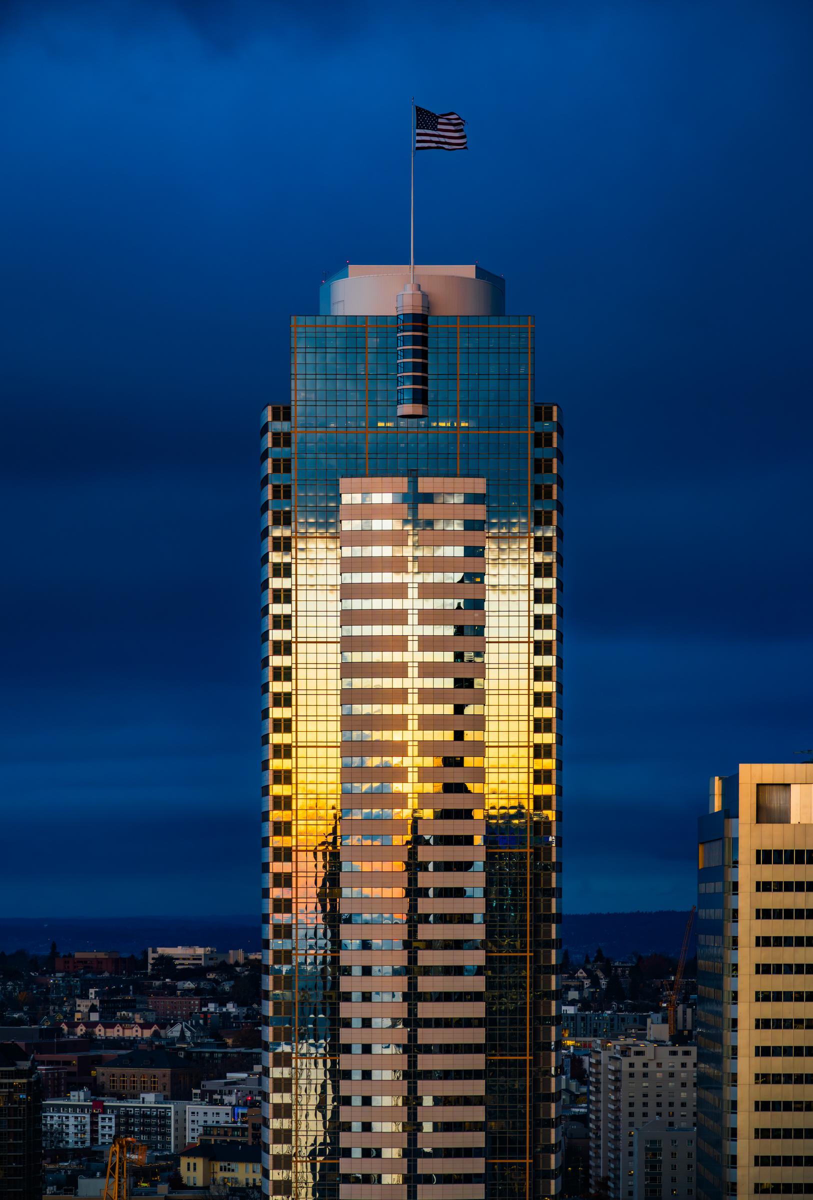 Tall building with American flag at dusk Seattle Washington United States