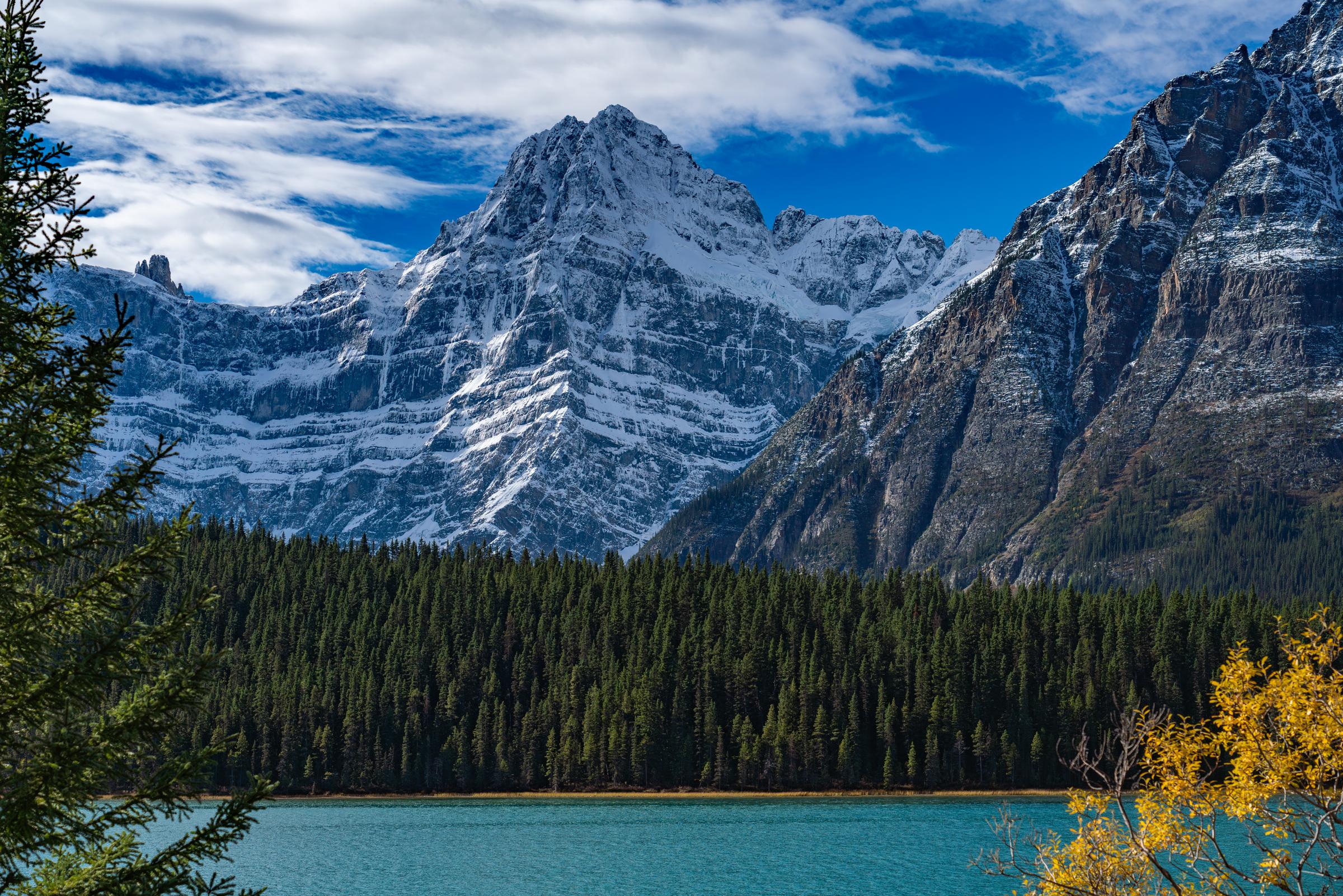 Snow-capped mountains overlooking a lake Icefields Parkway British Columbia Canada