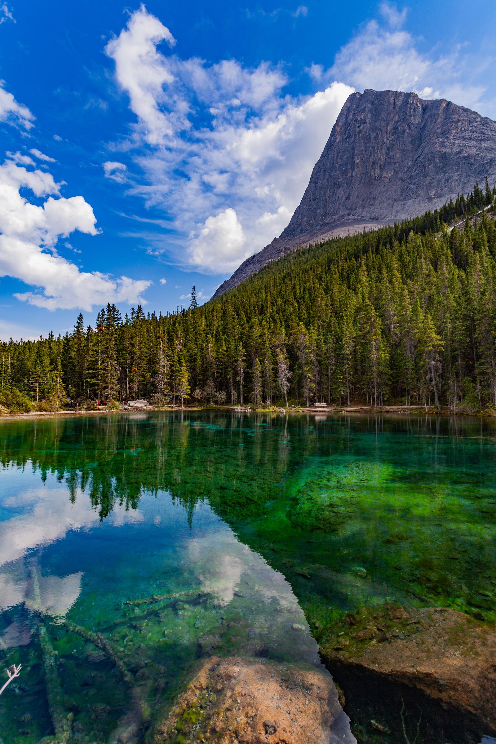 Clear lake reflecting forest and mountain Grassi Lakes AB Canada