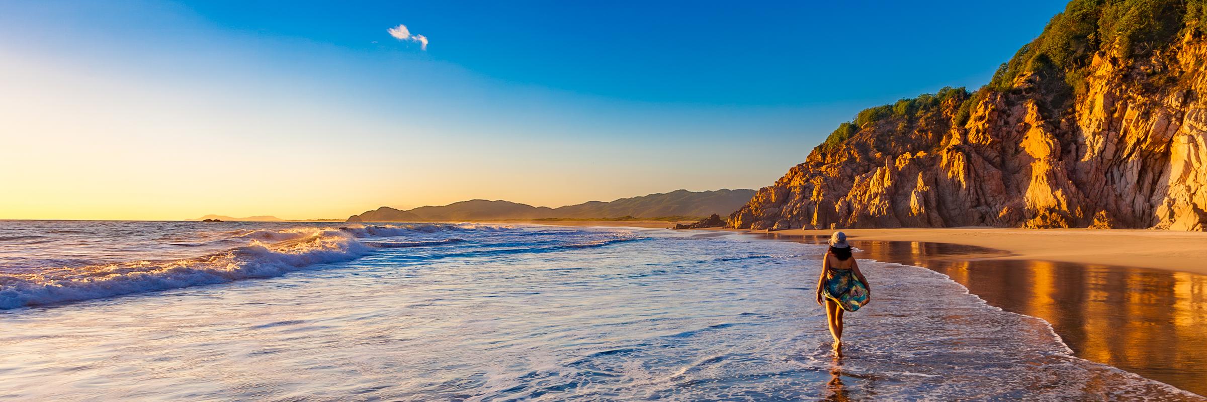 Person walking on beach at sunset Manzanillo Colima Mexico