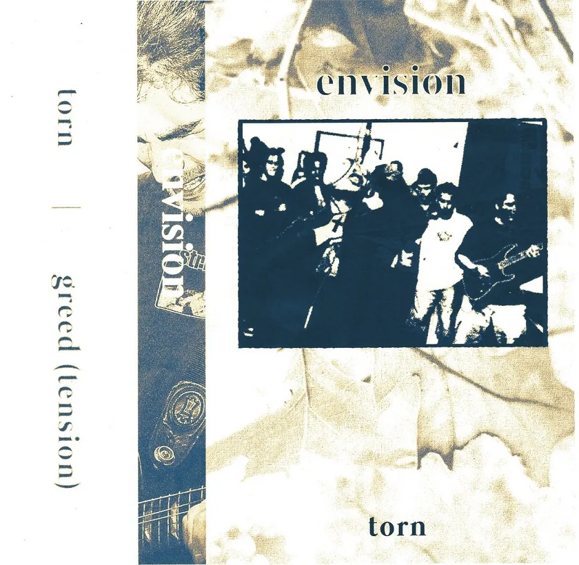 Torn b/w Greed cover